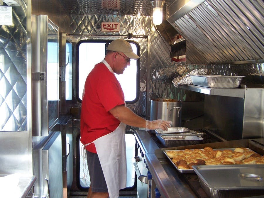 Volunteer preparing a meal for residence after a storm 